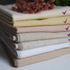 A bundle of seven pieces assorted colors of solid linen fabric.